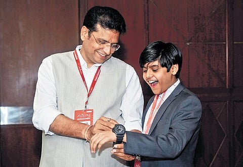 IT Minister Sridhar Babu gifts his watch to Siddharth Nandyala at the AI Summit