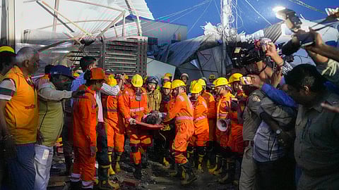 An injured being rescued after a three-storey building collapsed, crushing a truck under its debris, at Transport Nagar area in Lucknow, Saturday, Sept. 7, 2024.