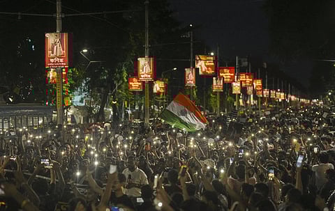 People take part in a protest march over the alleged sexual assault and murder of a trainee doctor, in Kolkata, Sunday, Sept. 8, 2024.