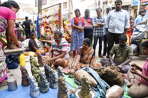 Daily wage workers making clay Vinayaga idols for Vinayagar Chathurthi sale in Tiruchy on Saturday.