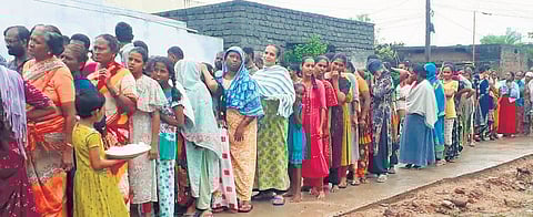 People from the flood-affected areas of Khammam are seen waiting in a queue for food on Sunday