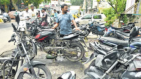 A mechanic repairing two-wheelers in Vijayawada on Monday.