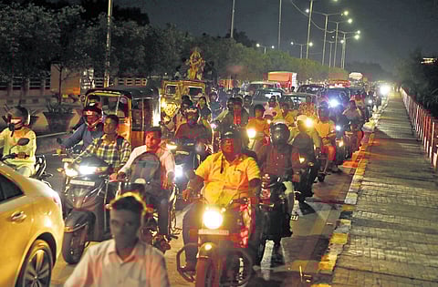 Commuters stuck in a traffic jam on the Khairatabad flyover in the city on Monday