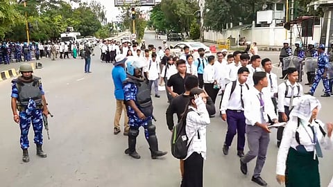 ecurity personnel keep vigil during a protest march by members of All Manipur Students' Union (AMSU) against the recent violence in the state, in Imphal.