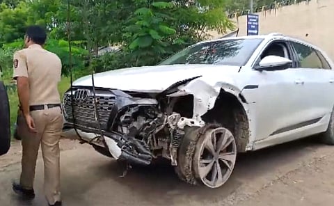 A police personnel near the damaged Audi owned by Maharashtra BJP chief Chandrashekhar Bawankule's son Sanket Bawankule, after it allegedly hit several vehicles, in Nagpur.