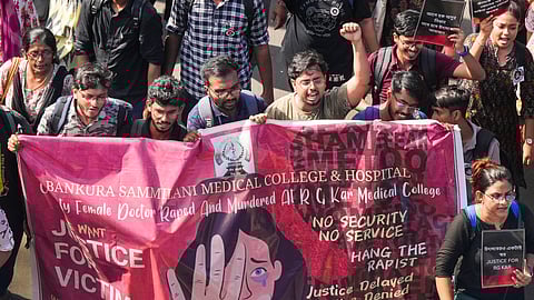 Junior doctors shout slogans as they march towards Swasthya Bhawan during a protest over RG Kar Hospital's rape and murder incident, in Kolkata.