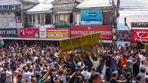 Protestors, who had gathered on the call of Hindu groups, remove a security barricade during a protest demanding the demolition of a mosque in the Sanjauli locality of Shimla.