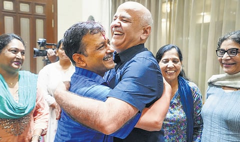 Delhi Chief Minister Arvind Kejriwal being greeted by party leader Manish Sisodia as he arrives at his residence on Friday.