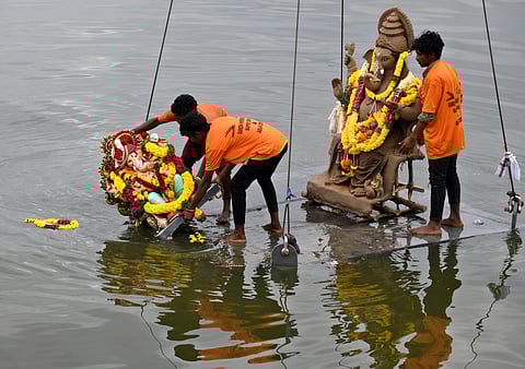 People seen immerssing Ganesh idols at Hussain sagar lake near peoples plaza in Hyderabad on Thursday