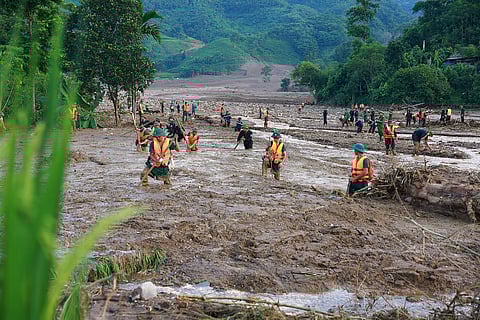 Rescue workers search for the missing after a flash flood buries a hamlet in mud and debris in the aftermath of Typhoon Yagi in Lao Cai province, Vietnam Thursday, Sept. 12, 2024.