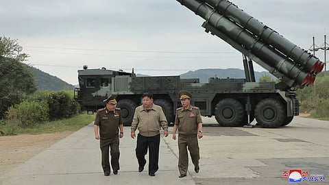 In this undated photo provided on Friday, Sept 13, 2024, by the North Korean government, its leader Kim Jong Un, center, walks with other officials near what it says is their new launch vehicle of 600 mm multiple rockets at an undisclosed location in North Korea.
