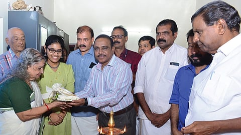 Uthrada Kizhi being presented to N K Saumyavathi Thampuratti by Kottayam District Collector John V Samuel