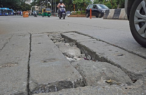 A massive pothole in the centre of a main road.