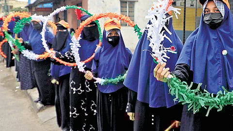 To mark the International Day of Democracy, students form a human chain on Mysuru Road in Bengaluru on Sunday
