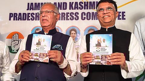 Congress leader Pawan Khera with JKPCC chief Tariq Hameed Qara releases the party's manifesto for upcoming Assembly elections, in Srinagar.