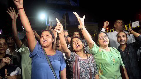 People raising slogans near Chief Minister Mamata Banerjee's house in Kolkata on Monday.