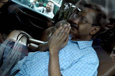 Aam Aadmi Party leader and former chief minister of Delhi Arvind Kejriwal gestures as he leaves the Lieutenant Governor of Delhi's office