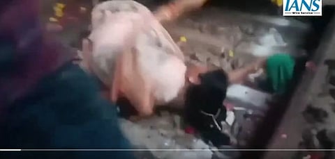 Video screengrab of BJP's Etawah MLA Sarita Bhadauriya falling onto the railway tracks while vying to wave the green flag for the Agra-Varanasi Vande Bharat Express