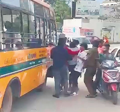 A video grab shows the miscreants roughing up the driver of the school bus