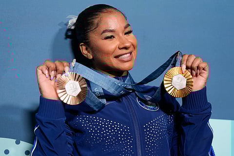 Jordan Chiles, of the United States, holds up her medals after the women's artistic gymnastics individual apparatus finals Bercy Arena at the 2024 Summer Olympics.
