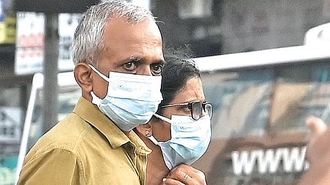 An elderly couple wears face masks at Mavoor Road in Kozhikode as the health department has intensified disease control measures after the recent Nipah outbreak