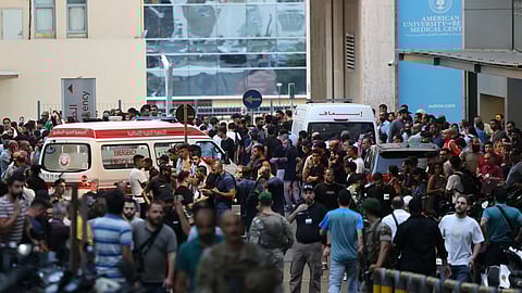 Ambulances are surrounded by people at the entrance of the American University of Beirut Medical Center, on September 17, 2024, after explosions hit locations in several Hezbollah strongholds around Lebanon amid ongoing cross-border tensions between Israel and Hezbollah fighters.