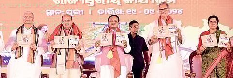 Chief Minister Mohan Charan Majhi, deputy CMs KV Singh Deo and Pravati Parida, BJP’s Odisha president Manmohan Samal and state in-charge VP Singh Tomar present the report card of the first 100 days of BJP government at a function in Puri, on Thursday