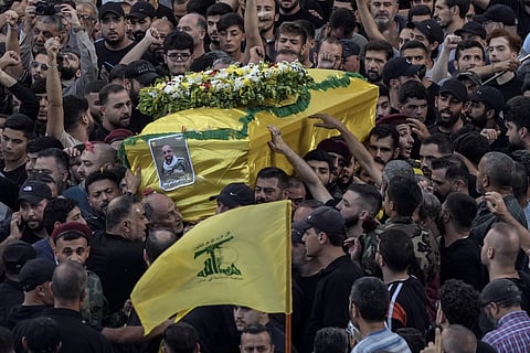 Mourners carry the coffin of Mohammed Mahdi, son of Hezbollah legislator Ali Ammar, who was killed Tuesday after his handheld pager exploded, in the southern suburb of Beirut, Lebanon, Wednesday, Sept 18, 2024.