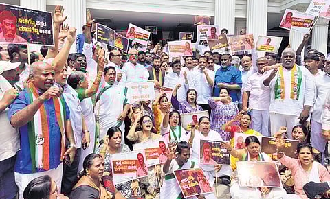 Congress supporters protest against MLA Munirathna in Bengaluru on Thursday