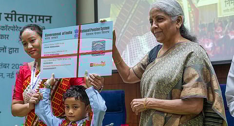 Union Finance Minister Nirmala Sitharaman with a child during the launch of NPS Vatsalya Scheme, in New Delhi, Wednesday, Sept. 18, 2024.
