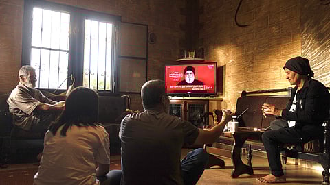 People attend a televised speech by the leader of the Hezbollah movement Hassan Nasrallah inside a house in the southern Lebanese village of Zawatar on September 19, 2024.