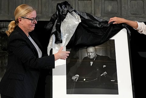 Canadian Cultural Heritage Deputy Minister, Isabelle Mondou, left, unveils a photographic portrait known as 'The Roaring Lion', taken by photographer Yousuf Karsh in 1941 of Britain's Prime Minister Winston Churchill, stolen in Canada in 2022, and returned during a ceremony at the Canada's embassy in Rome, Thursday, Sept. 19, 2024.