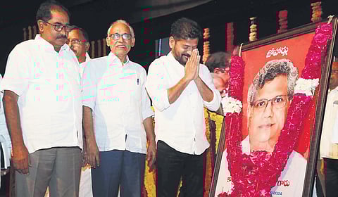Chief Minister A Revanth Reddy pays floral tributes to
a portrait of Sitaram Yechury during a memorial meeting organised at Ravindra Bharathi in Hyderabad on Saturday