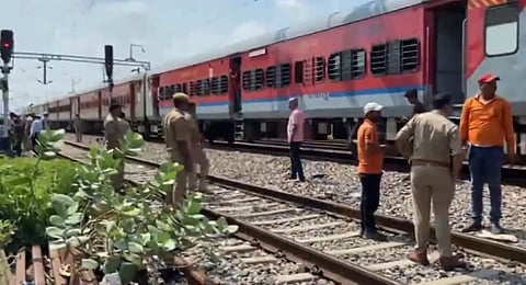 Police personnel inspect the spot where a 5-litre empty gas cylinder was found on tracks just as a goods train was about to pass through at Prempur Station in Kanpur on Sunday.