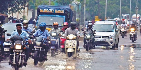 Vehicles passing through waterlogged road at Pattalam on Tuesday