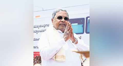 Chief Minister Siddaramaiah greets the gathering after flagging off ambulances at Vidhana Soudha in Bengaluru on Monday