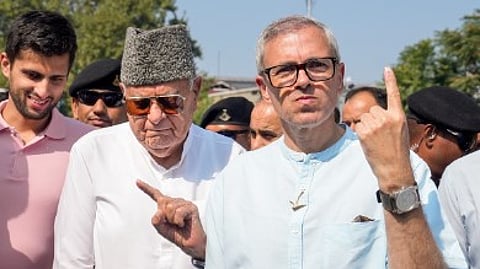 Jammu and Kashmir National Conference (JKNC) President Farooq Abdullah and Vice President Omar Abdullah show their fingers marked with indelible ink after casting vote during the second phase of J&K Assembly elections, in Srinagar, Wednesday, Sept. 25, 2024.
