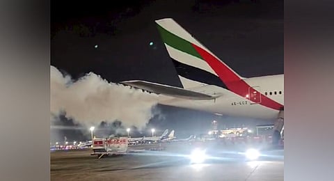 Smoke emnates from the tail end of a Dubai-bound Emirates flight at the Chennai International Airport, Tuesday night, Sept. 24, 2024.