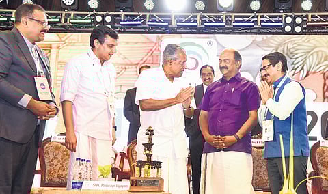 Chief Minister Pinarayi Vijayan greets former chief secretary V Venu after honouring him for his contributions to the state’s tourism industry, at the Kerala Travel Mart inaugural function at Le Meridien, Kochi, on Thursday