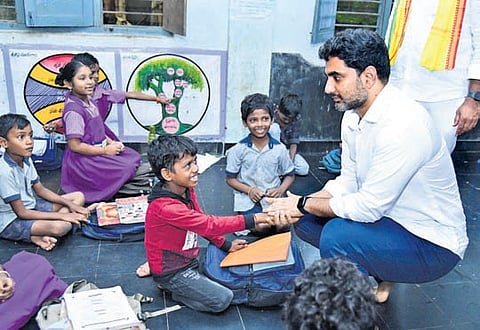 HRD Minister N Lokesh interacts with children during his surprise visit to a primary school in Srikakulam on Thursday