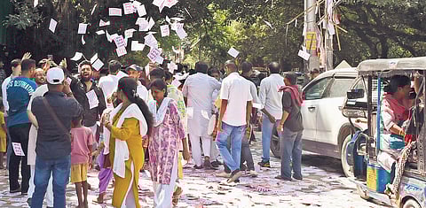 Scenes from Delhi University on Friday — a lot of flyers were seen scattered on the road; long queues of voters were noticed at some places outside the polling booths