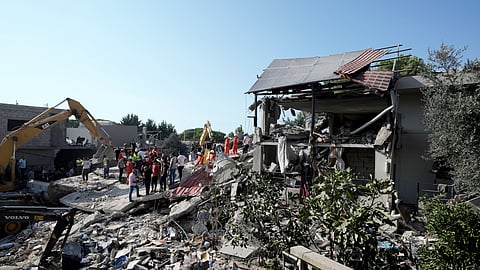 Emergency workers arrive at the scene of an Israeli airstrike in the town of Maisara, north of Beirut.