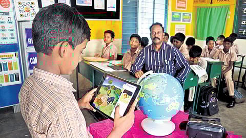 The classroom is adorned with a smart board, podcasting space, a projector and speakers