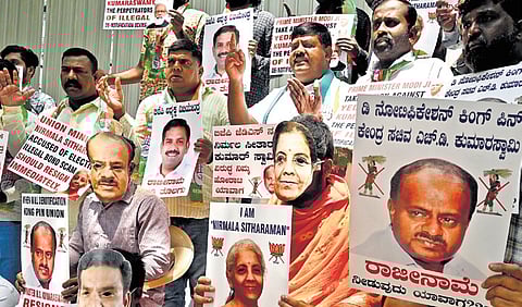 Congress workers protest against Union Ministers Nirmala Sitharaman and HD Kumaraswamy seeking their resignation in Bengaluru on Saturday