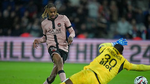 PSG's Bradley Barcola, left, scores his side's third goal during the French League One soccer match between Paris Saint-Germain and Rennes at the Parc des Princes in Paris.