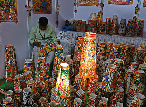 An Artist is seen colouring the bed lamp units at SARAS Exhibition in peoples plaza in Hyderabad.