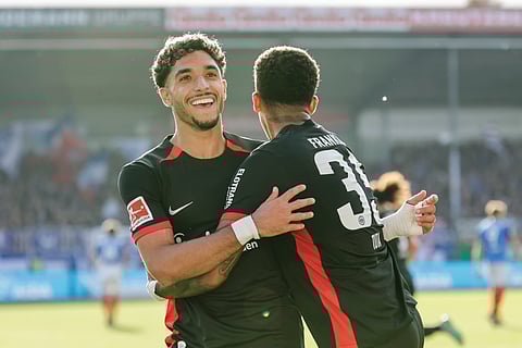 Frankfurt's Omar Marmoush, left, and Lucas Tuta-Silva Melo celebrate after scoring their side's fourth goal during the Bundesliga soccer match between Holstein Kiel and Eintracht Frankfurt, at the Holstein Stadium in Kiel, Germany, Sunday, Sept. 29, 2024.