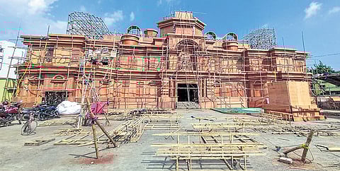 Workers busy erecting the structure of the Imperial Palace at Jharapada