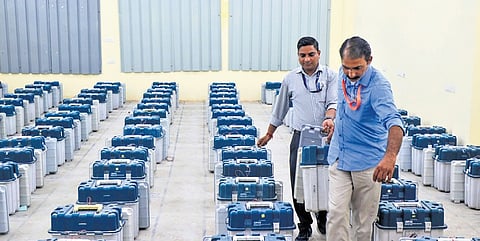 Polling officials during distribution of EVMs ahead of elections.