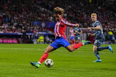 Atletico Madrid's Antoine Griezmann attempts a shot at goal during the Champions League opening phase soccer match against RB Leipzig at the Metropolitano stadium, in Madrid.